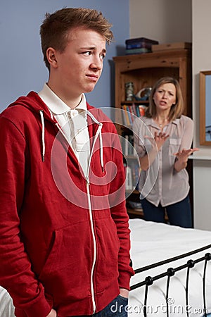 Teenage Boy Being Told Off By Mother Stock Photo