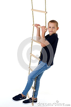 Teenage boy climbiing on rope ladder Stock Photo