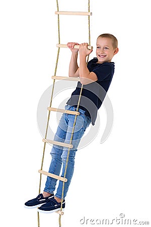 Teenage boy climbiing on rope ladder Stock Photo