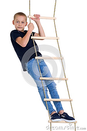 Teenage boy climbiing on rope ladder Stock Photo