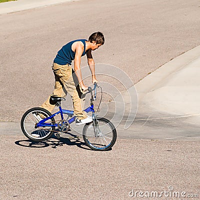 Teenage boy doing tricks on a BMX bike. Stock Photo