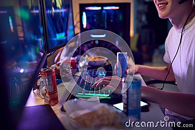 Teenage Boy Drinking Caffeine Energy Drink Gaming At Home Using Dual Computer Screens At Night Stock Photo