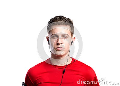 Teenage boy with earphones, in red sports sweatshirt. Isolated. Stock Photo