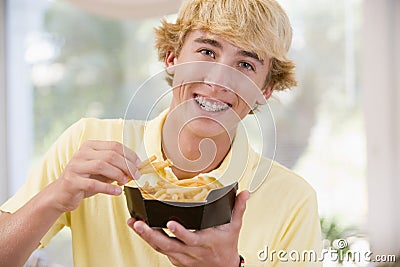 Teenage Boy Eating French Fries Stock Photo
