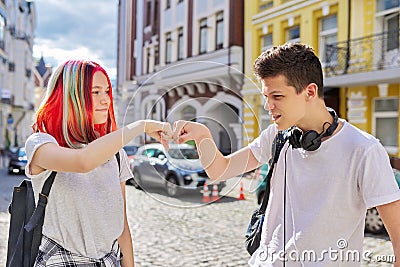 Teenage boy and girl meeting, greeting with hands Stock Photo