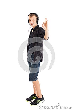 Teenage boy with headphones showing sign Ok Stock Photo