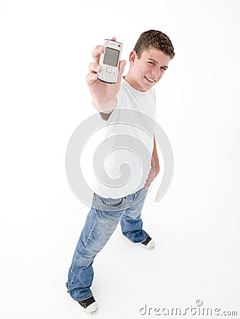 Teenage boy holding up cellular phone and smiling Stock Photo