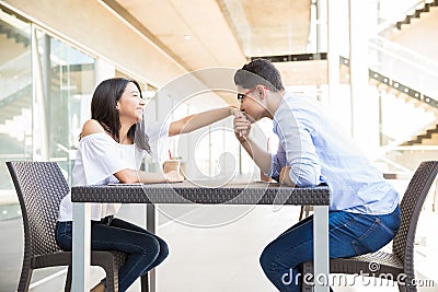 Teenage Boy Kissing Girlfriend`s Hand At Shopping Center Stock Photo