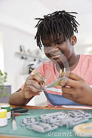 Teenage Boy Making Model Aeroplane From Kit On Table At Home Stock Photo