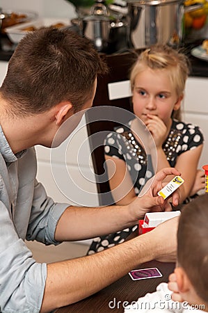 Teenage boy playing card game with his sister Stock Photo