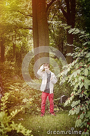 Teenage boy standing in nature Stock Photo