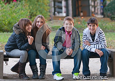 Teenage boys and girls having fun in the park Stock Photo