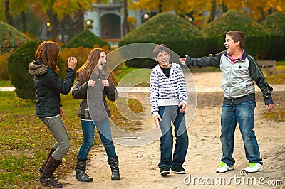 Teenage boys and girls having fun in the park Stock Photo