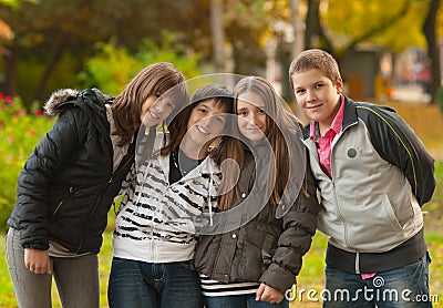 Teenage boys and girls having fun in the park Stock Photo