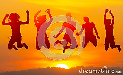 Teenage boys and girls jumping high in the air against sunset Stock Photo