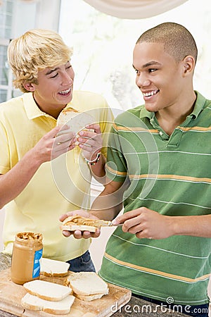 Teenage Boys Making Sandwiches Stock Photo