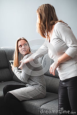 Teenage daughter unhappy about her mother limiting her screen time Stock Photo