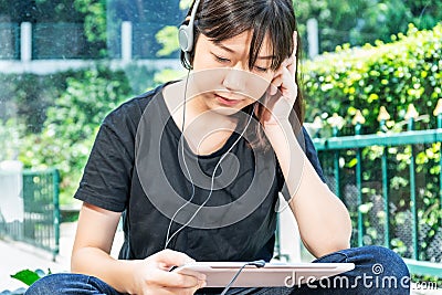 Teenage female learning to the music from a digital tablet Stock Photo