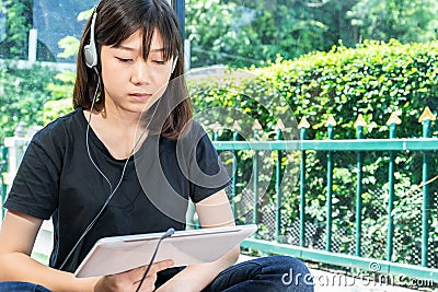 Teenage female learning to the music from a digital tablet Stock Photo