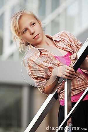 Teenage girl against a school building Stock Photo