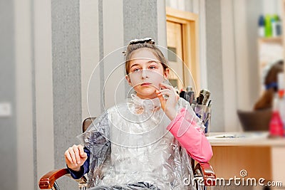 Teenage girl in a beauty salon on hair coloring and a haircut. Beauty concept. haircut, coloring Stock Photo