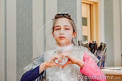 Teenage girl in a beauty salon on hair coloring and a haircut. Beauty concept. haircut, coloring Stock Photo