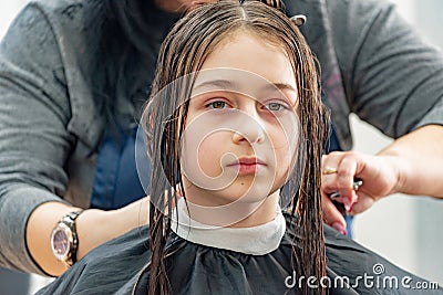 Teenage girl in a beauty salon on hair coloring and a haircut. Beauty concept. haircut, coloring Stock Photo