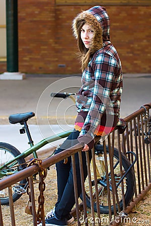 Teenage Girl on Bike Rack Stock Photo