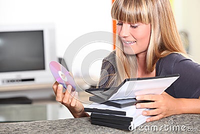 Teenage girl choosing a DVD Stock Photo