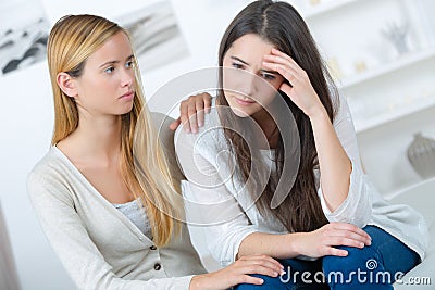 Teenage girl consoling friend Stock Photo