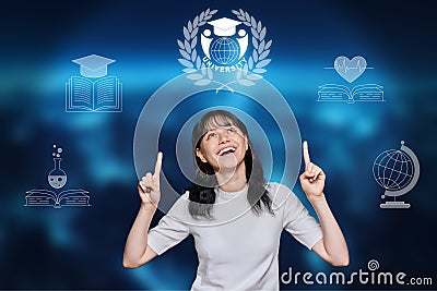 Teenage girl pointing with her hands at symbol of university Stock Photo