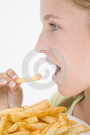 Teenage girl eating French fries Stock Photo