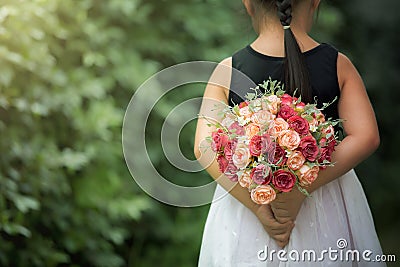 Teenage girl feeling happy holding a bouquet of flowers in the season of love Stock Photo
