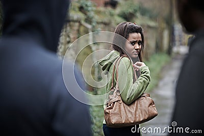 Teenage Girl Feeling Intimidated As She Walks Home Stock Photo