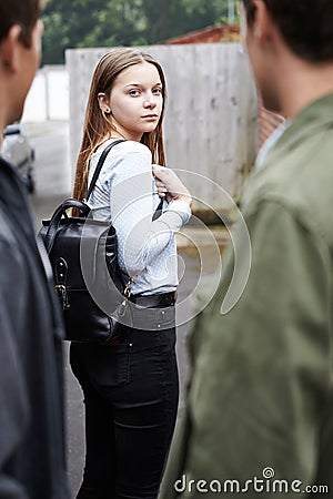 Teenage Girl Feeling Intimidated As She Walks Home Stock Photo