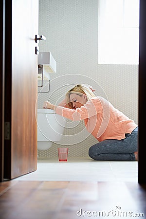 Teenage Girl Feeling Unwell In Bathroom Stock Photo