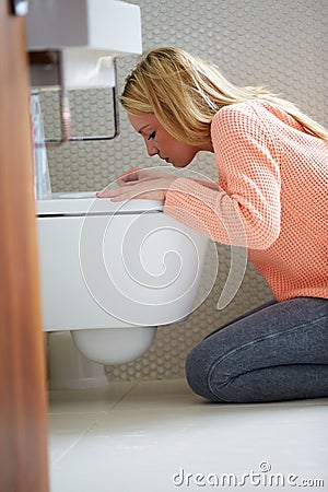 Teenage Girl Feeling Unwell In Bathroom Stock Photo