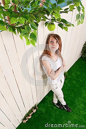 Teenage girl at the fence in the garden Stock Photo