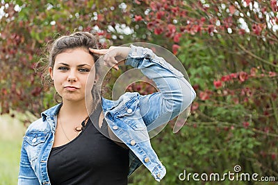 Teenage girl with finger pointing at her head Stock Photo