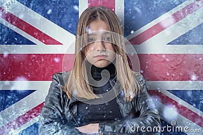 Teenage girl on frozen background with flag of Great Britan. Concept of crisis in Europe in winter. Energy crisis Stock Photo