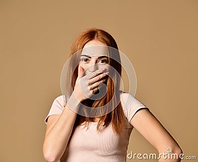 Cheerful woman having fun bursting into laughing keeping hand on mouth Stock Photo