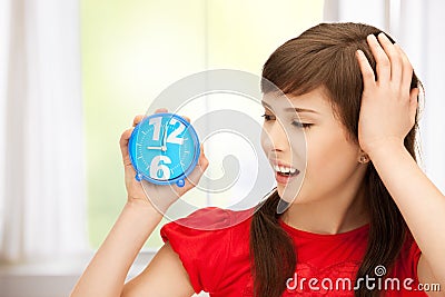 Teenage girl holding alarm clock Stock Photo