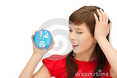 Teenage girl holding alarm clock Stock Photo