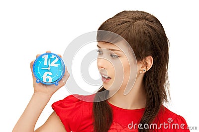 Teenage girl holding alarm clock Stock Photo