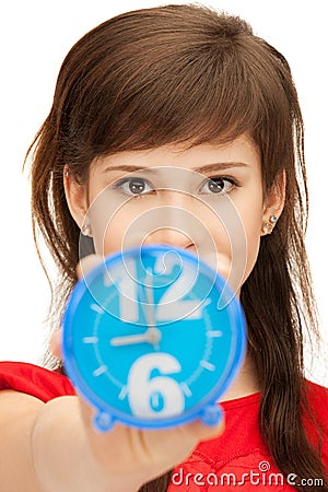 Teenage girl holding alarm clock Stock Photo