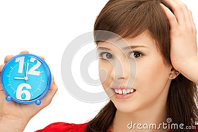 Teenage girl holding alarm clock Stock Photo