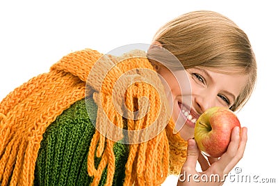 Teenage girl holding apple laughing Stock Photo