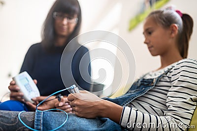 Teenage girl holding zapper electrodes Stock Photo