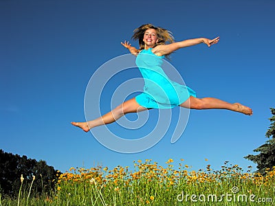 Teenage girl jumping in the meadow Stock Photo