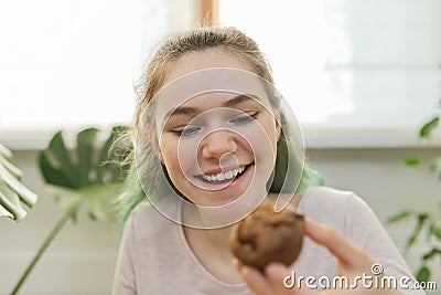 Teenage girl leads culinary vlog, girl shows freshly baked chocolate muffin Stock Photo